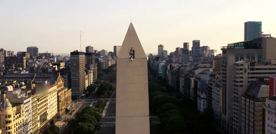 Aerial view of the Obelisco, Buenos Aires, above Avenida 9 de Julio in low warm light.